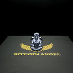 Metallic angel figurine with wings holding a Bitcoin symbol on a black background with 'Bitcoin Angel' text.